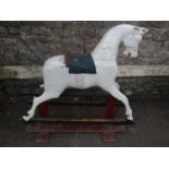 A vintage traditional rocking horse with trestle base and over painted finish (AF), 95 cm high