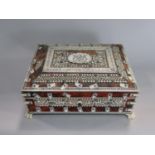 Tortoiseshell and ivory Vizagapatam casket, with hinged lid and four ivory paw feet, 22cm wide