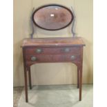 A small 19th century mahogany dressing table with oval swing mirror back over two frieze drawers,