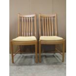 An Ercol light elm pull out extending dining table of rectangular form with moulded outline and
