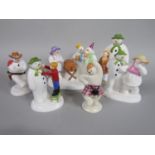 A collection of five Coalport Snowmen series figures including a money bank, Adding A Smile, The