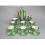 A Royal Doulton six place coffee service in the art deco manner with gilt prunus blossom
