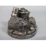 A silver applied character group of two hedgehogs amongst flowerpots in a garden setting, signed