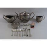A good quality cast silver plated three-piece half fluted tea service, with engraved scrolled