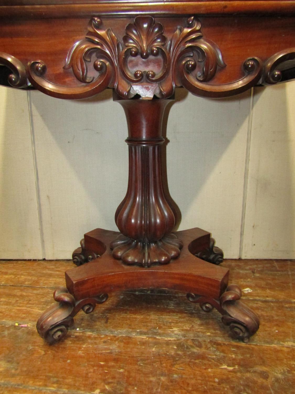 A Regency mahogany fold over top tea table, raised on a vase shaped pillar and platform base, with - Image 2 of 3