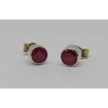 Pair of ruby stud earrings in unmarked white metal