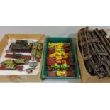 Collection of HO gauge model rail transporter wagons carrying military or construction vehicles