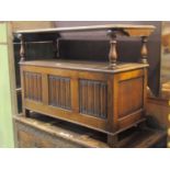 An early 20th century oak monks bench with sliding rectangular top over a box base with hinged lid