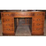 A reproduction Georgian style yew wood veneered kneehole pedestal writing desk, with triple inset