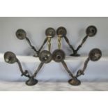 Four various cast metal twin branch wall sconces, together with a pair of brass candlesticks (6)