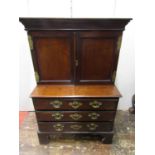 An unusual small antique mahogany side cabinet, the lower section fitted with three drawer, raised