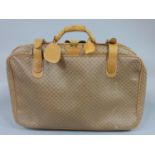 Gucci Suitcase printed with GG logo, constructed from durable canvas with pale leather trim, gold