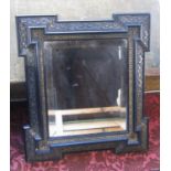 Antique style wall mirror, the fretwork frame with canted corners enclosing a bevelled mirror plate,