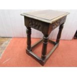 An old English oak coffin or joint stool with carved detail on turned supports, together with a