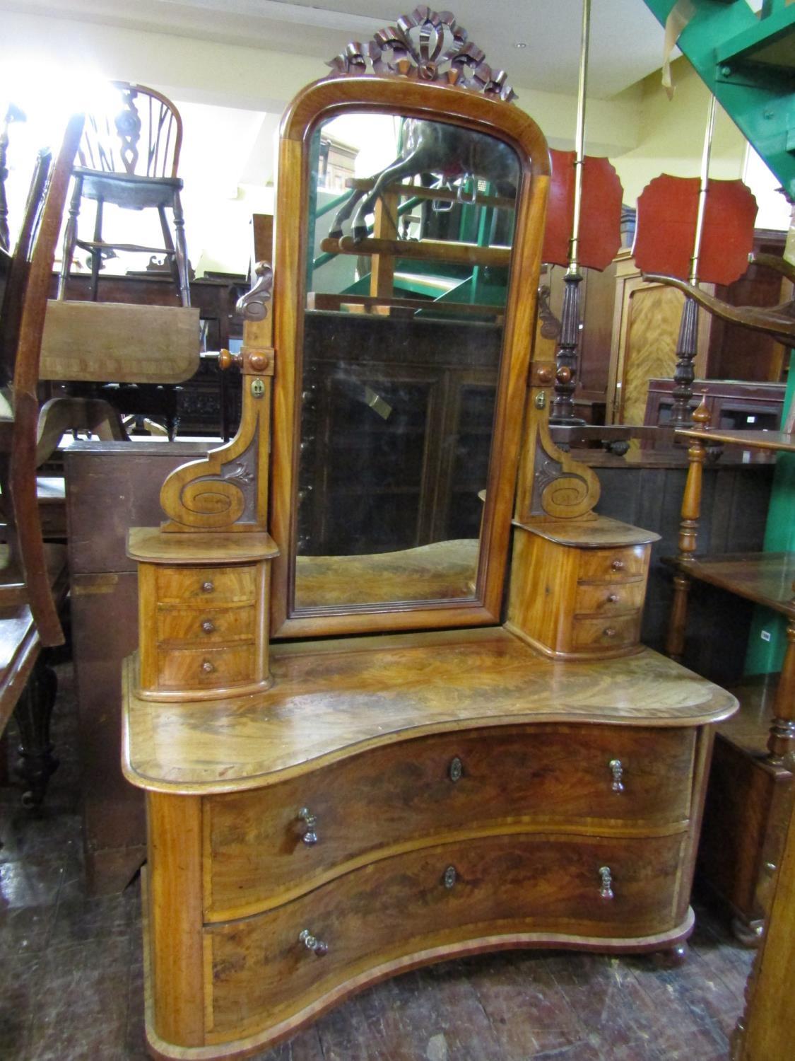 A good quality 19th century continental mahogany dressing table, the low set base of concave form,