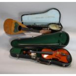 A collection of instruments to include a cased banjolele, a bowl back mandolin and a further three