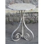 A small iron work garden/interior lamp table with circular top raised on scrolled supports united by