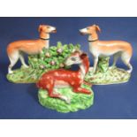 An early 19th century Staffordshire model in the Walton manner of a recumbent deer, with bocage,