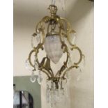 A cast gilt metal hanging ceiling light with open c scroll acanthus frame surrounding a moulded
