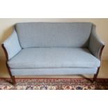 An Edwardian two seat settee, part show wood frame with inlaid detail, recently reupholstered in a