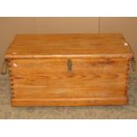 A 19th century stripped pine box with hinged lid and exposed dovetail construction