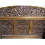 A Victorian oak hall bench or settle, the box base flanked by scrolled arms the raised back with