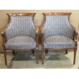 A pair of reproduction tub chairs with stained beechwood show wood frames and alternating striped