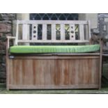 A Green Fingers contemporary teak two seat garden bench with partially pierced slatted back over a