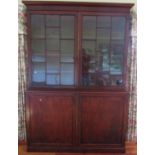 A good quality Georgian mahogany library bookcase, the lower section enclosed by two panelled
