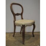 A set of six Victorian walnut balloon back dining chairs with scrolled acanthus bar splats,
