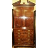 A Georgian mahogany secretaire bookcase, the base fitted with an arrangement of three drawers,