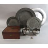 A collection of four antique pewter plates, together with a pair of ovoid silver plated dishes,