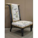 A late Victorian prie dieu of generous proportions with buttoned upholstered seat and T shaped
