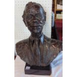 Cast bronze bust possibly of Prince Charles by Shenda Amery, on a black marble plinth base, signed