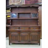 An old charm oak cottage dresser in the old English style, the base enclosed by three linen fold
