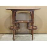 An Arts & Crafts style oak occasional table of oval form raised on turned tapered supports united by