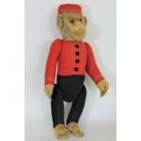 Schucco Bellhop Yes/ No monkey C1920's with brown glass eyes, fur head, felt face, in red and