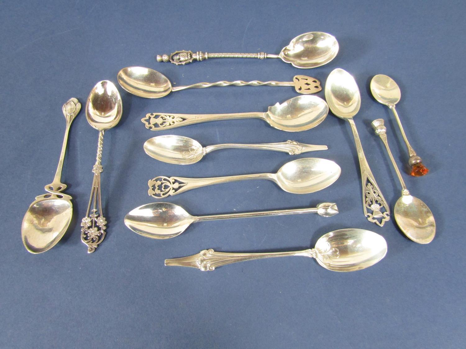 A collection of good novelty and souvenir spoons, many with thistle decoration and other pierced and