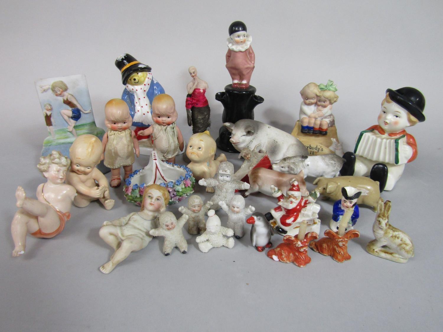 A collection of mainly early to mid-20th century novelty cake ornaments including Snow Babies,