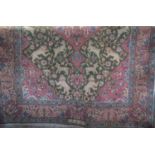 Persian full pile tree of life type rug, central pink medallion, framed by scrolled foliate and