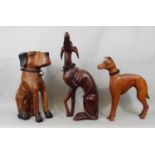 Three carved timber figures of dogs including a whippet, 49 cm and smaller, a vintage googly eyed