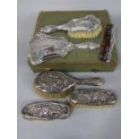 Edwardian three piece dressing set comprising three brushes embossed with scrolled fuchsias, maker