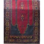 Baluchi type rug with central Islamic red panel upon a navy blue ground, 250 x 140cm