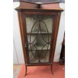An inlaid Edwardian mahogany freestanding corner cupboard with chequered string inlay, the glazed