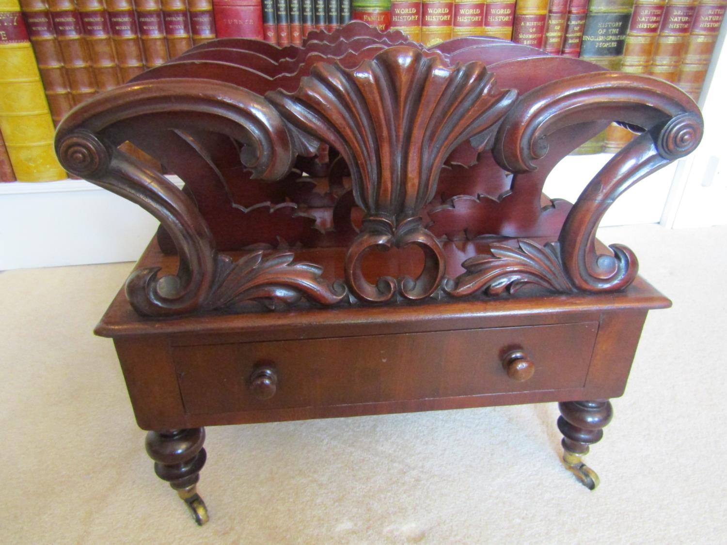 A Regency mahogany four divisional Canterbury, with carved and scrolled detail, over a single frieze