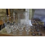 A large collection of glassware to include a storm lantern, decanters, various hand painted