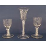 Three latticino stemmed cordial glasses, each etched with floral sprays on wide feet, the largest