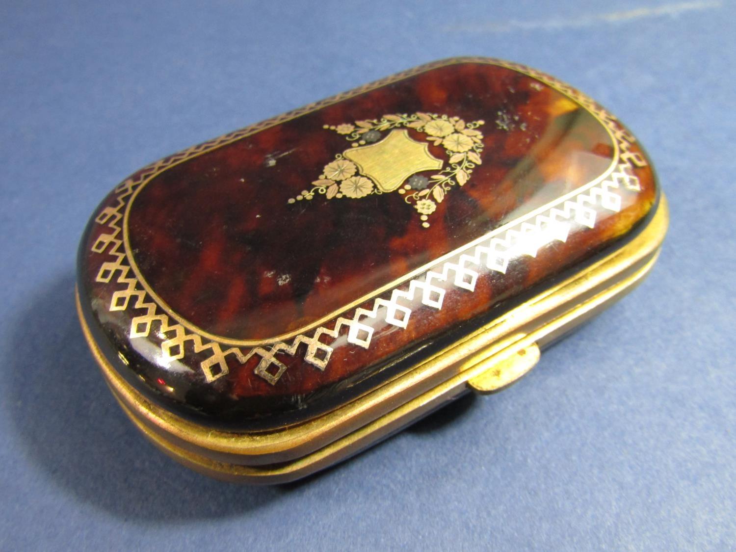 19th century tortoiseshell purse with gold inlaid detail, and a floral frieze within a repeating