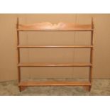 A stripped pine flight of open wall shelves with shaped outline, 83 cm wide x 12 cm deep x 87 cm