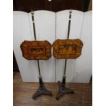 A pair of Regency rosewood pole screens on tricorn bases, with lower fluted columns, the upper